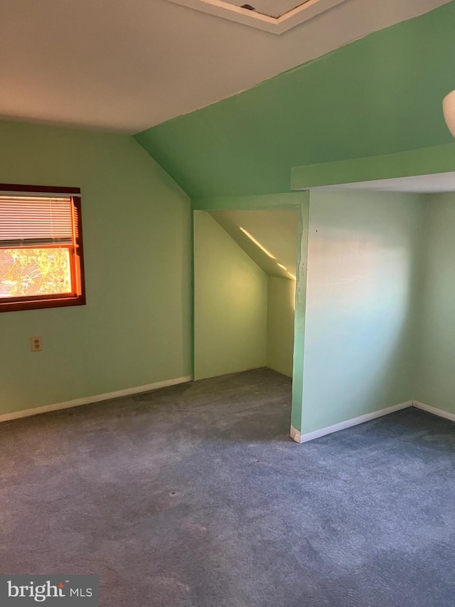 additional living space with carpet flooring and vaulted ceiling