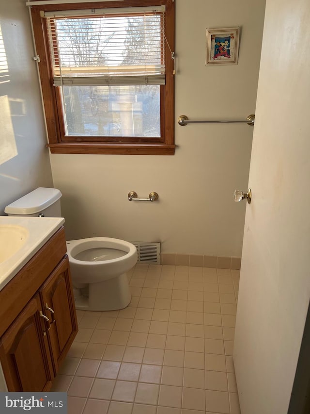 bathroom with vanity, tile patterned flooring, and toilet