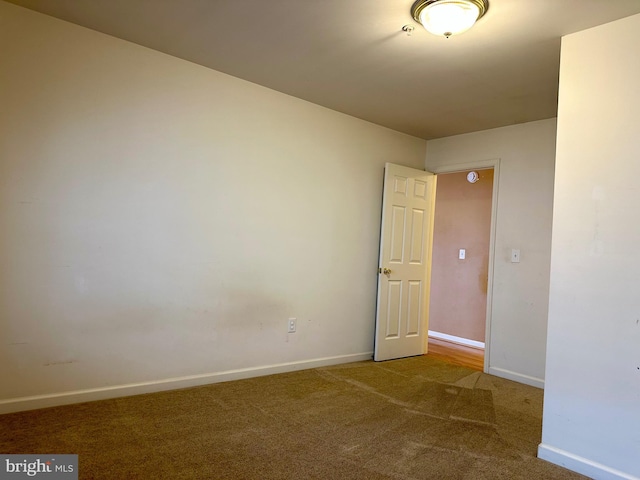 empty room with carpet floors and baseboards