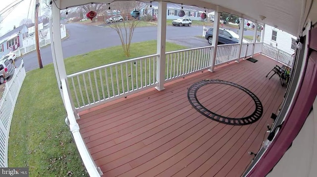 wooden terrace with a porch and a lawn