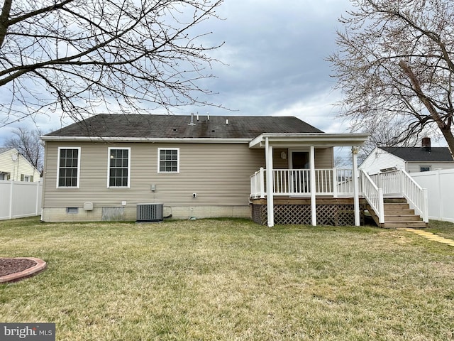 rear view of house featuring a deck, a yard, a fenced backyard, and central air condition unit