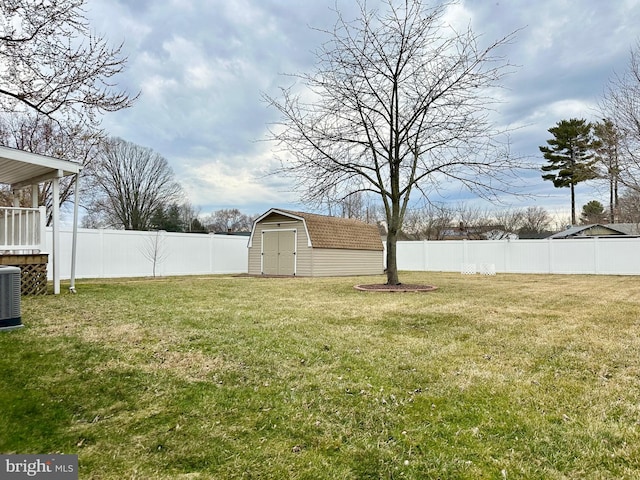 view of yard featuring a storage shed, a fenced backyard, and an outdoor structure