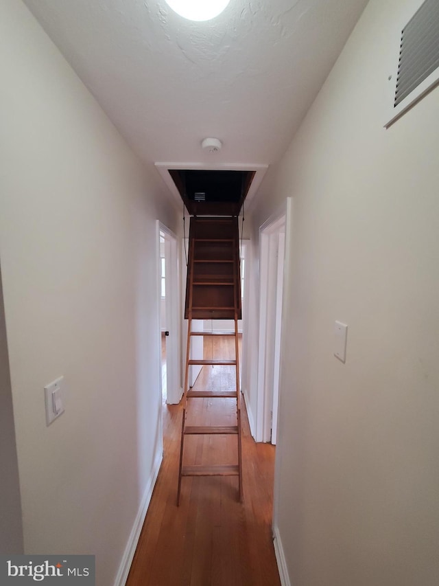 corridor featuring hardwood / wood-style flooring