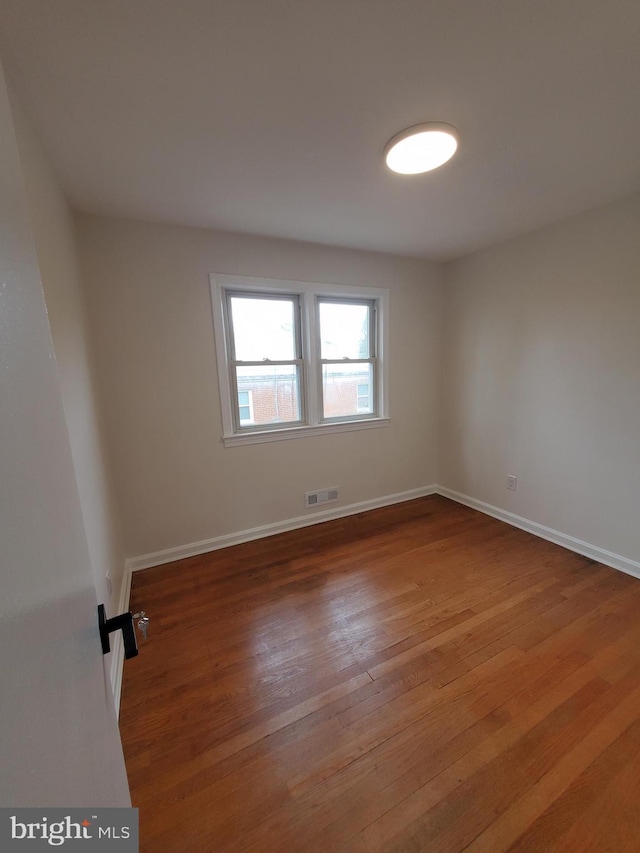 empty room with wood-type flooring