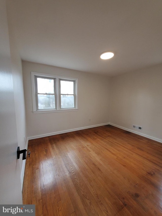 unfurnished room with hardwood / wood-style floors