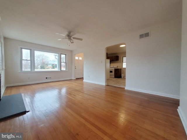 unfurnished living room with ceiling fan and light hardwood / wood-style flooring