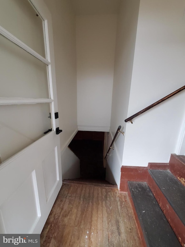 stairs featuring hardwood / wood-style flooring