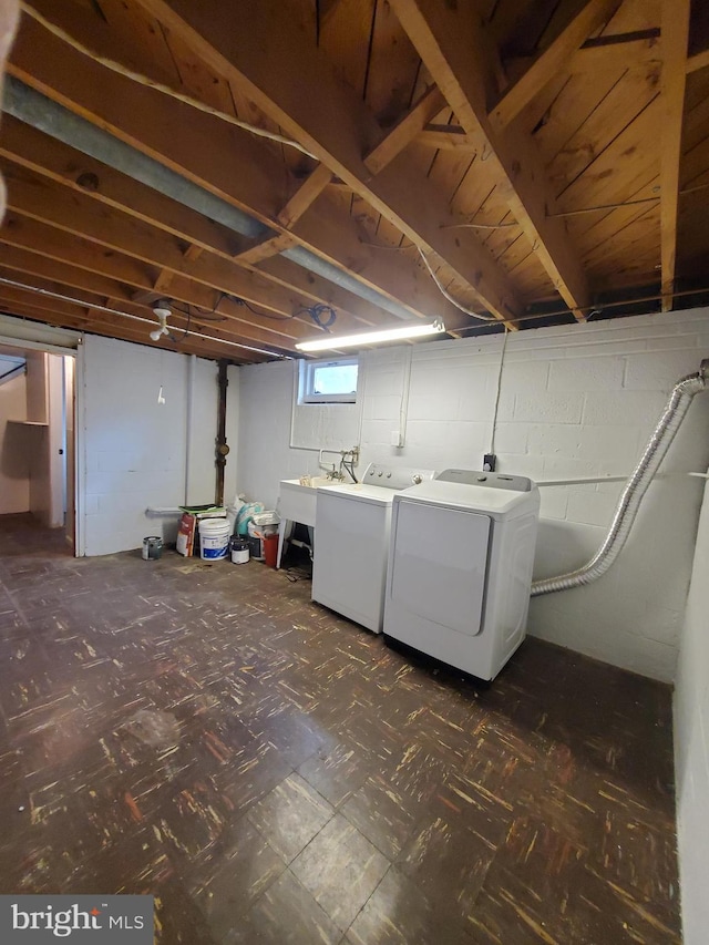 basement with sink and washer and clothes dryer