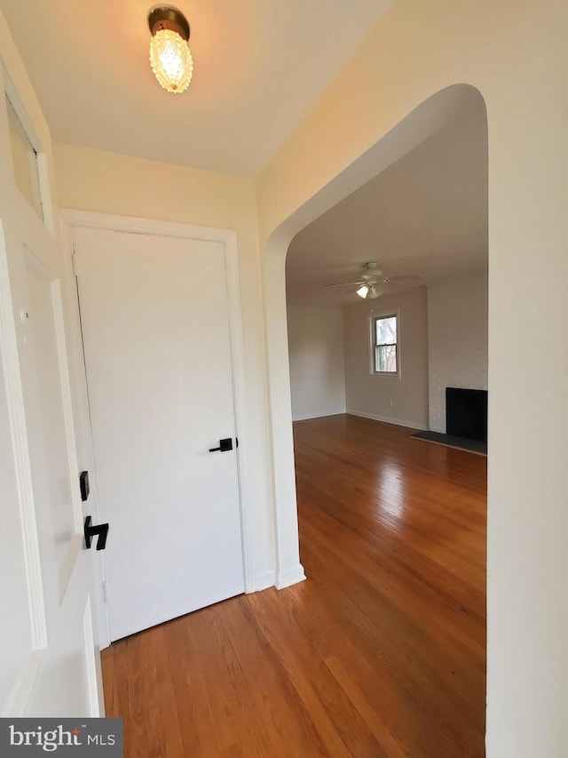 hallway with hardwood / wood-style floors