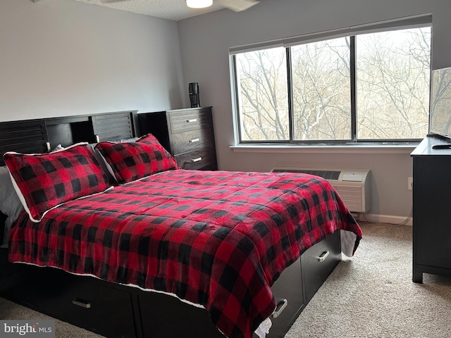 carpeted bedroom with a wall mounted AC and baseboards