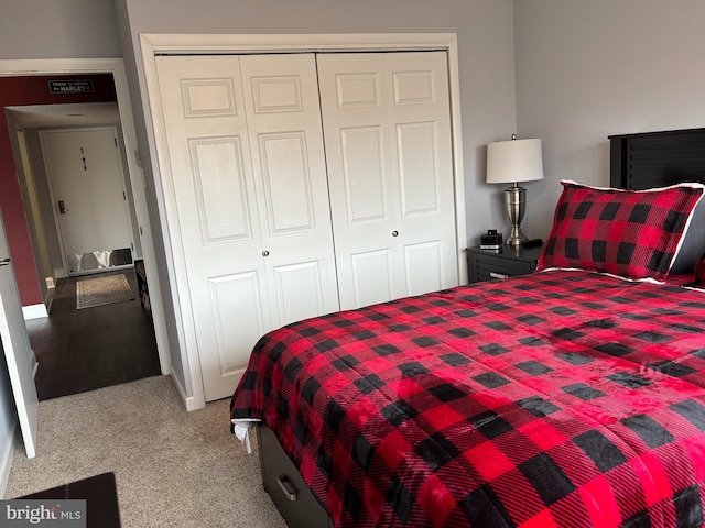 bedroom featuring light carpet and a closet