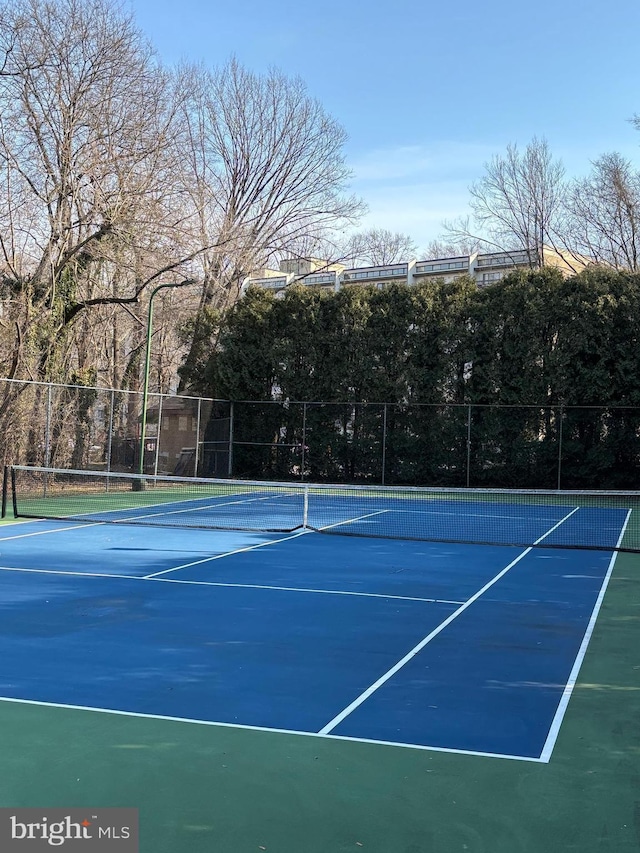 view of tennis court with fence