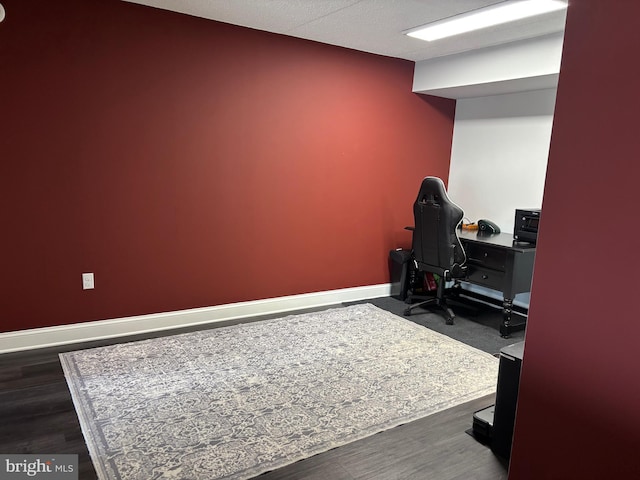 home office with baseboards and dark wood finished floors