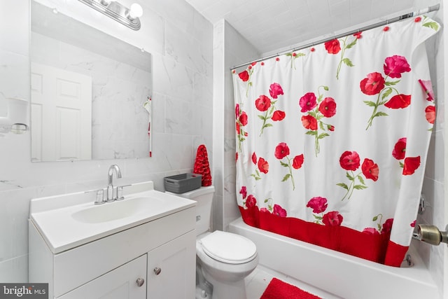 full bathroom featuring vanity, toilet, shower / bath combo with shower curtain, and tile walls