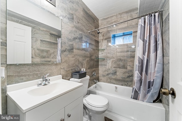 full bathroom featuring shower / tub combo with curtain, vanity, toilet, and tile walls