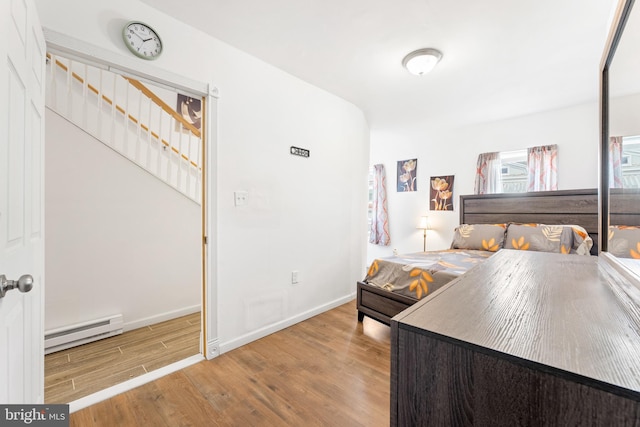 bedroom featuring light hardwood / wood-style flooring and a baseboard radiator