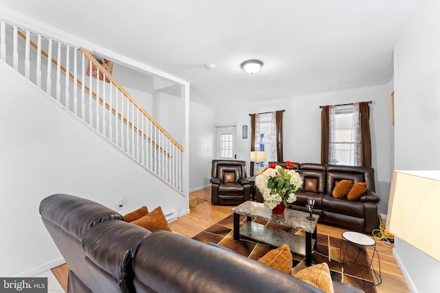 living room featuring a baseboard radiator and light hardwood / wood-style flooring