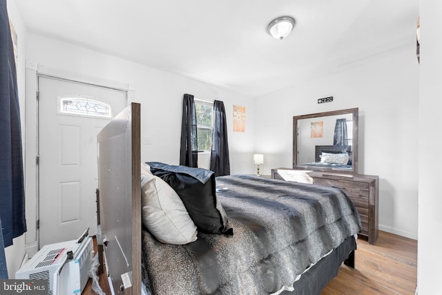 bedroom with hardwood / wood-style flooring