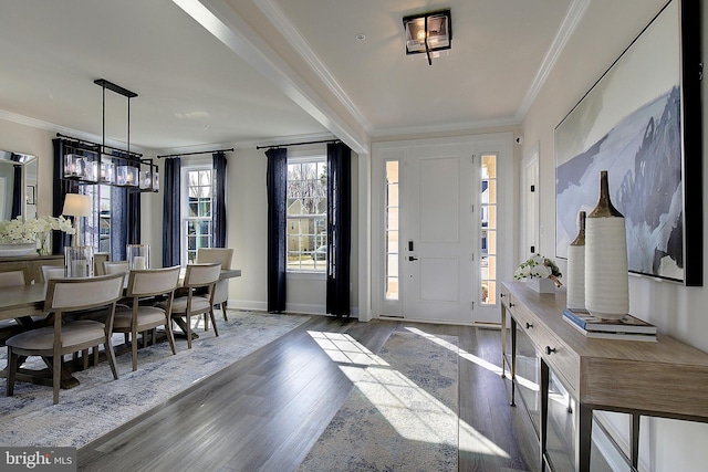 entrance foyer featuring crown molding and wood-type flooring