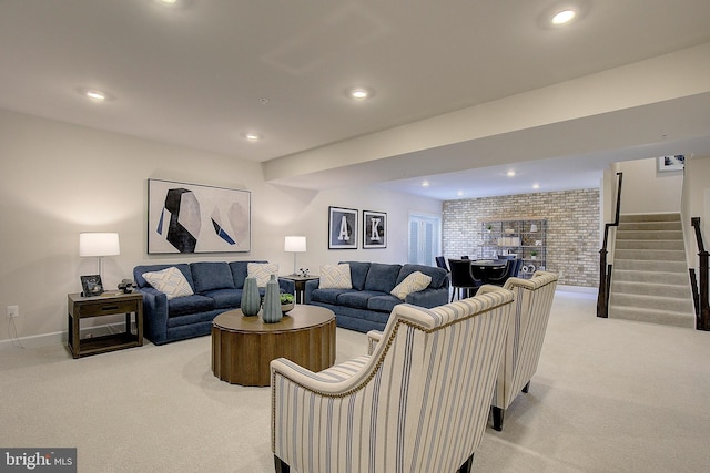 living room featuring brick wall and light colored carpet