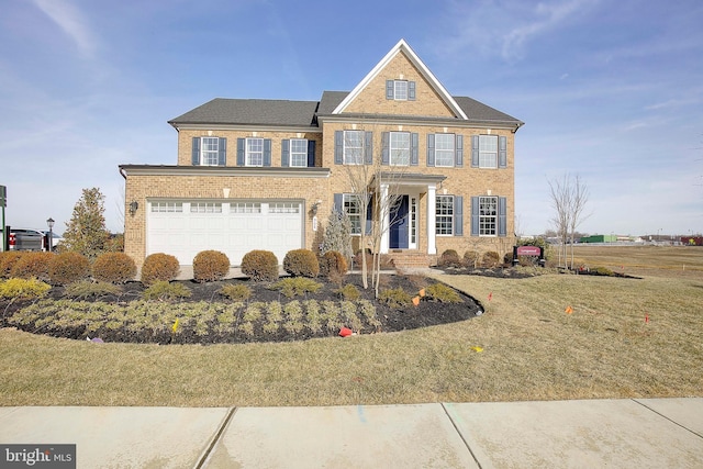 colonial house featuring a garage and a front yard