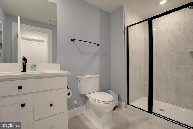 bathroom with vanity, tile patterned floors, a shower with door, and toilet