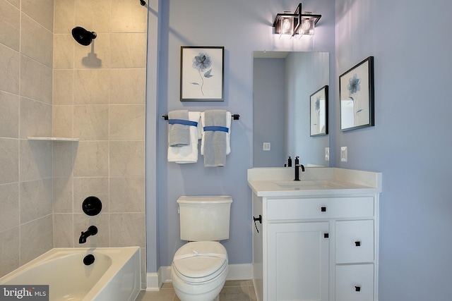 full bathroom with vanity, tiled shower / bath, and toilet