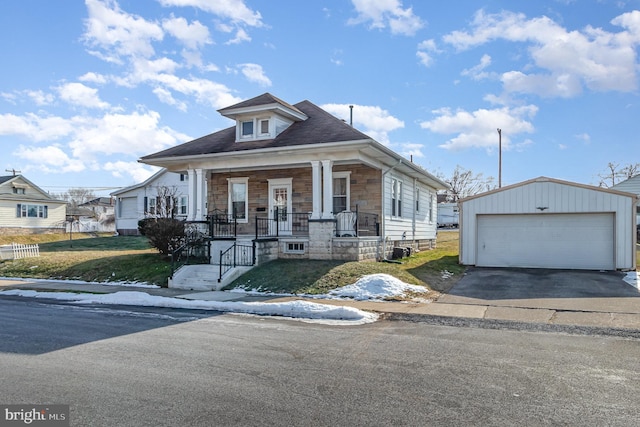 bungalow-style house with a garage, an outdoor structure, and covered porch