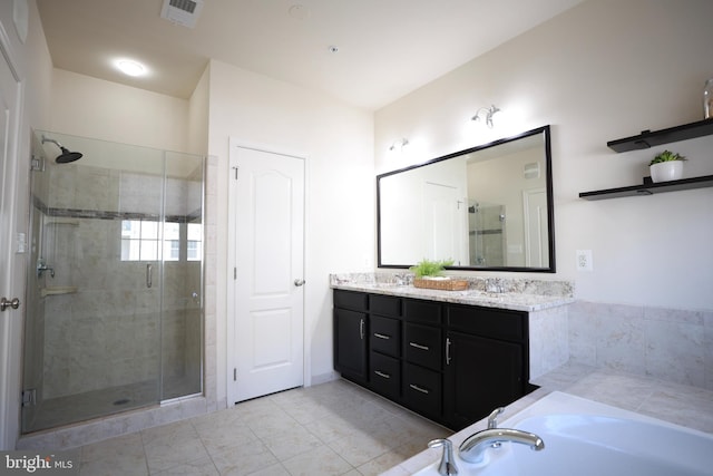 bathroom with vanity and shower with separate bathtub