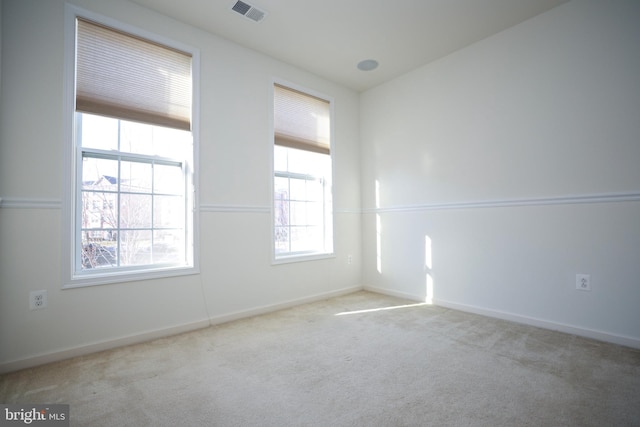 empty room with light colored carpet