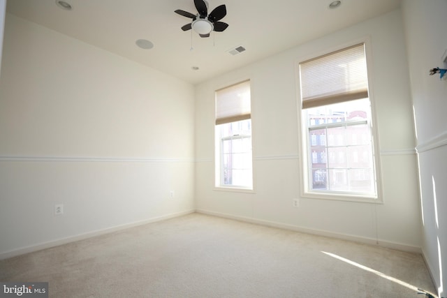 spare room with light carpet and ceiling fan