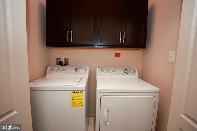 laundry room with cabinets and washer and dryer