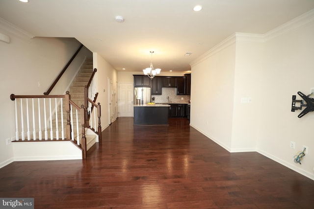 interior space with a notable chandelier, crown molding, and dark hardwood / wood-style floors