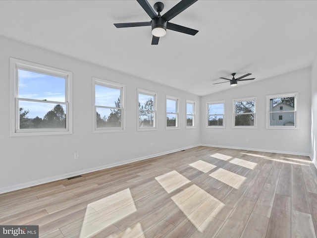 spare room featuring ceiling fan, light wood-type flooring, and a wealth of natural light