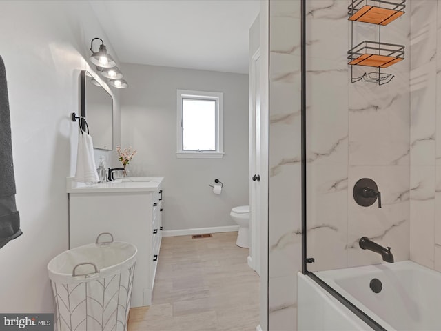 full bathroom featuring vanity, toilet, and tiled shower / bath combo