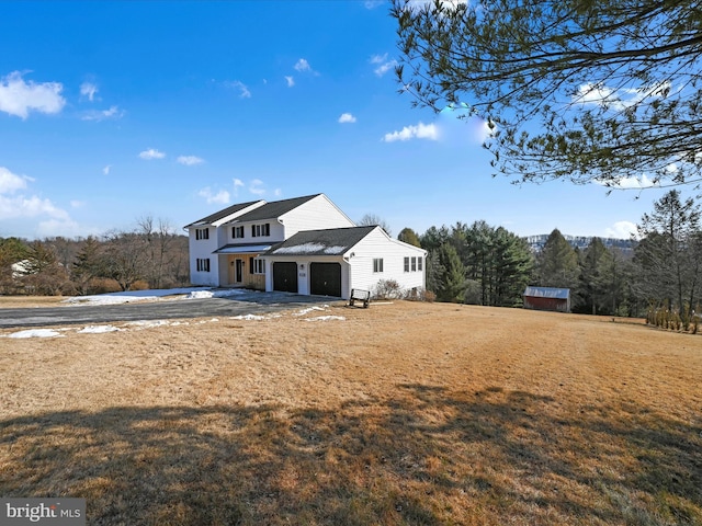 exterior space featuring a garage and a front yard