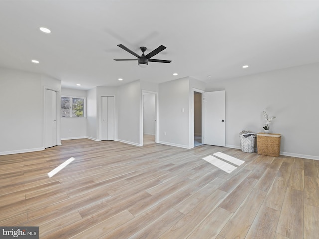 unfurnished living room with ceiling fan and light hardwood / wood-style flooring