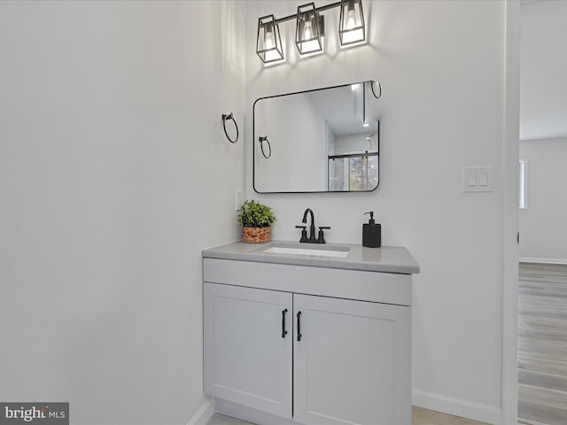 bathroom featuring vanity, hardwood / wood-style floors, and plenty of natural light