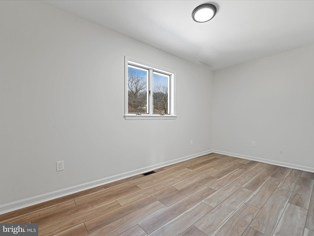 spare room with light hardwood / wood-style flooring