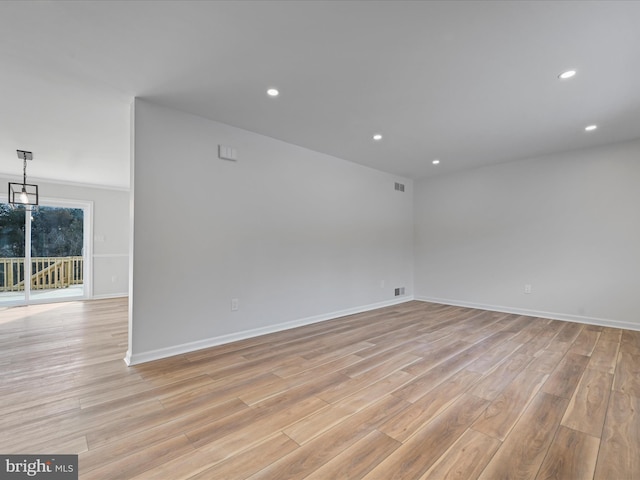 spare room with light hardwood / wood-style floors