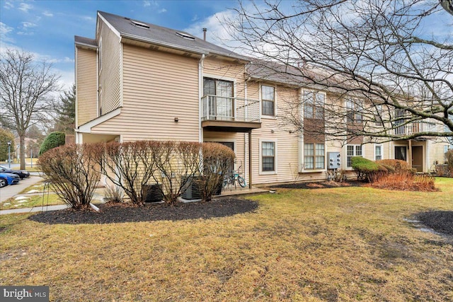 rear view of property featuring a yard