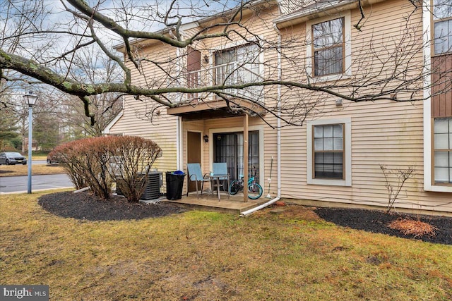 rear view of house with a yard and a patio area