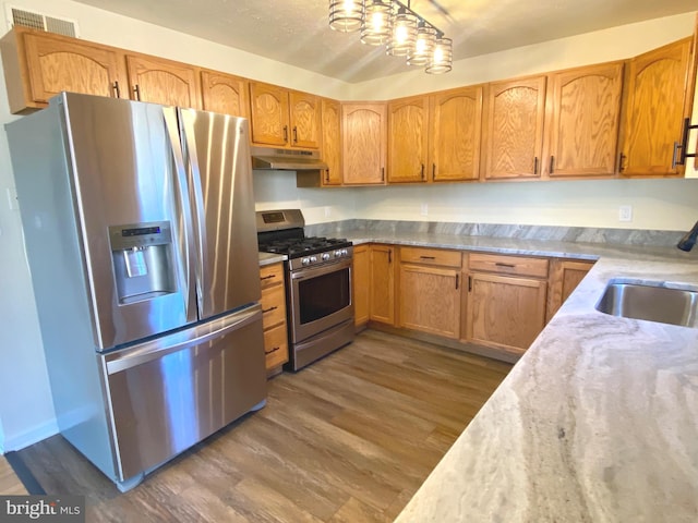 kitchen featuring sink, stainless steel appliances, and dark hardwood / wood-style floors