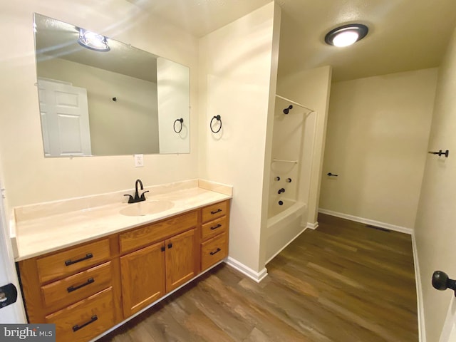 bathroom featuring vanity, hardwood / wood-style flooring, and shower / bathtub combination