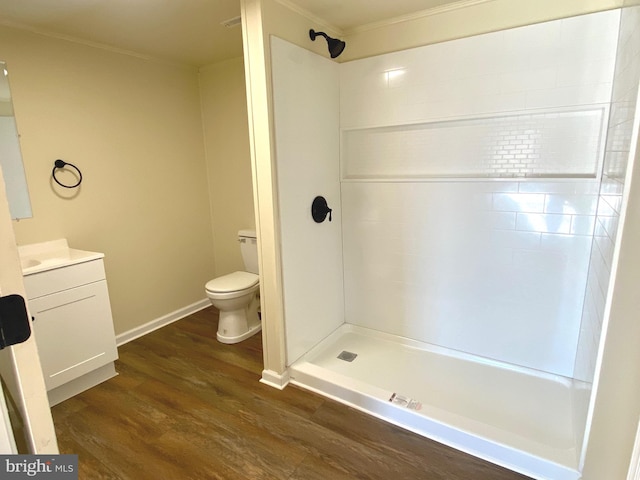 bathroom featuring wood-type flooring, a shower, vanity, and toilet