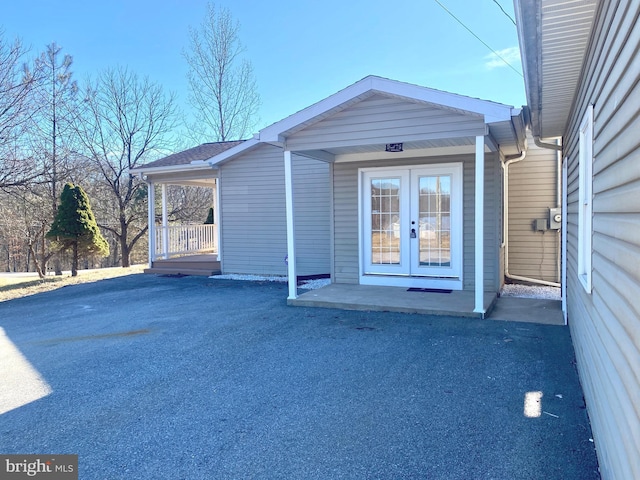 entrance to property with french doors and a porch