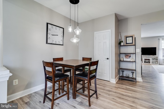 dining space featuring light wood-type flooring