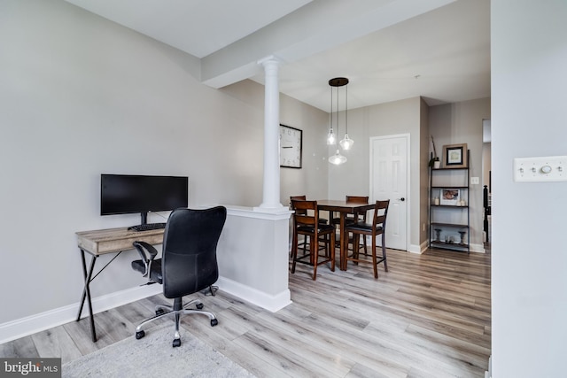 home office with decorative columns and light wood-type flooring