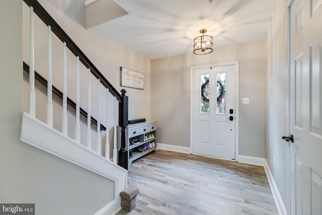 entryway featuring an inviting chandelier and light wood-type flooring