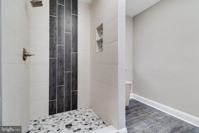 bathroom featuring tiled shower and hardwood / wood-style floors